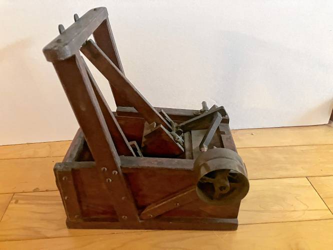 Petersham Historical Society's unidentified mechanism has been identified as a salesman's sample of a fulling machine. Fulling machines were used in mills in the early 1800s to finish wool fabric.