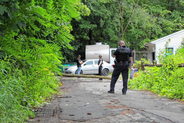 Police stand outside 24 Maple St. in Orange on Friday afternoon after a tree fell on a car, injuring three women who were inside. Police stand outside 24 Maple St. in Orange on Friday afternoon after a tree fell on a car, injuring three women who were inside.