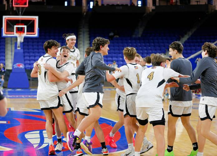 Pioneer players storm the court to celebrate after their 49-28 win over Hopedale for the MIAA Div. 5 state championship Saturday at the Tsongas Center in Lowell. 