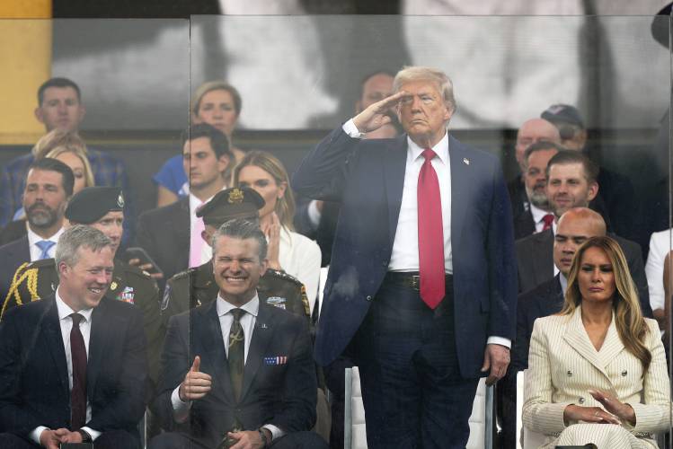 President Donald Trump salutes as he attends a military parade commemorating the Army’s 250th anniversary, coinciding with his 79th birthday, Saturday, June 14, 2025, in Washington, as Secretary of the Army Daniel Driscoll, Defense Secretary Pete Hegseth, and first lady Melania Trump, watch. President Donald Trump salutes as he attends a military parade commemorating the Army’s 250th anniversary, coinciding with his 79th birthday, Saturday, June 14, 2025, in Washington, as Secretary of the Army Daniel Driscoll, Defense Secretary Pete Hegseth, and first lady Melania Trump, watch.