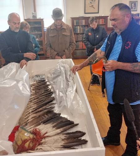 Justin Pourier, Fifth Member and Tribal Historic Preservation Officer of the Oglala Sioux Tribe, sings a prayer over items being returned to the Pine Ridge Reservation in South Dakota. 