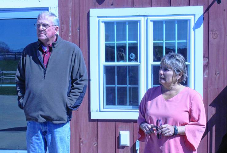 Tim Smith, who co-owns Apex Orchards in Shelburne with Courtney Basil, and former state Sen. Anne Gobi, now Gov. Maura Healey’s director of rural affairs, listen as Basil speaks during a visit by Kate Fox, executive director at the Massachusetts Office of Travel and Tourism, on Friday.