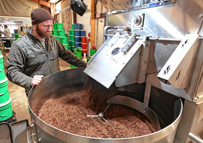 Brendan Walsh, head roaster and coffee buyer at Dean’s Beans Organic Coffee Co. in Orange with beans just out of the roaster.