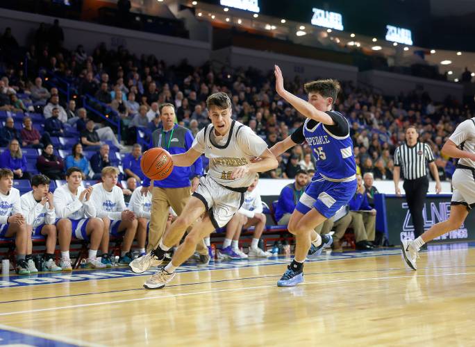 Pioneer’s Brayden Thayer (10) drives the ball past Hopedale defender Keigan Murphy (15) in the first quarter of the MIAA Div. 5 state championship Saturday at the Tsongas Center in Lowell. 