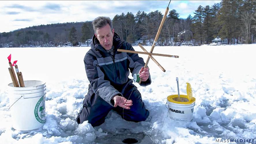 Mass Wildlife aquatic biologist Jim Legacy demonstrates using a tip-up.