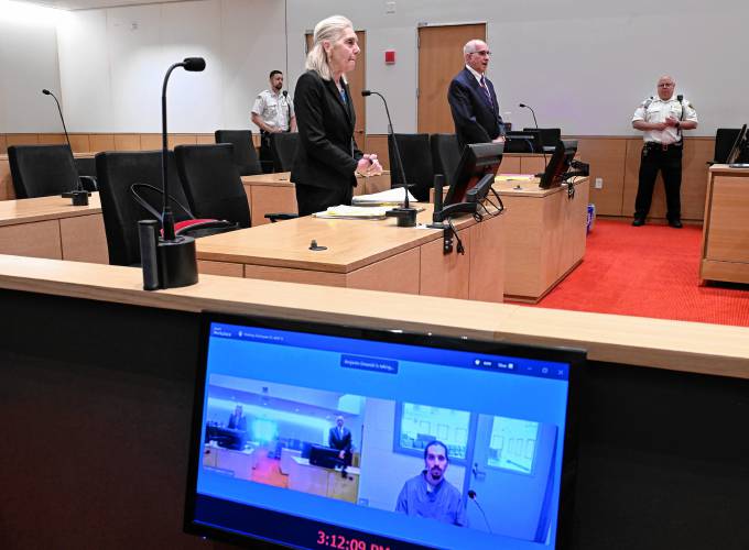 Joshua Hart, convicted in 2018 of killing Orange residents Thomas Harty and Joanna Fisher, appears in Franklin County Superior Court via Zoom from the Souza-Baranowski Correctional Facility on Tuesday afternoon while legal counsel stands in the courtroom. Hart is represented by attorney Stephen Maidman, background, while Assistant District Attorney Cynthia Von Flatern is working the case for the state.