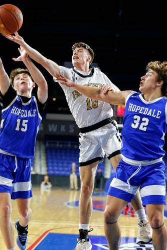 Pioneer’s Brayden Thayer (10) reaches for a rebound against Hopedale defenders Keigan Murphy (15) and Brayden Lewis (32) in the second quarter of the MIAA Div. 5 state championship Saturday at the Tsongas Center in Lowell. 