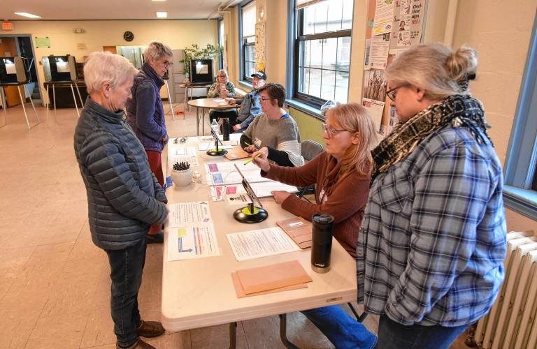 Residents check in to vote on Tuesday in Conway Town Hall.