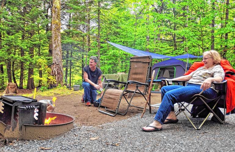 Campers enjoy a campfire at their DAR State Forest campsite in Goshen.