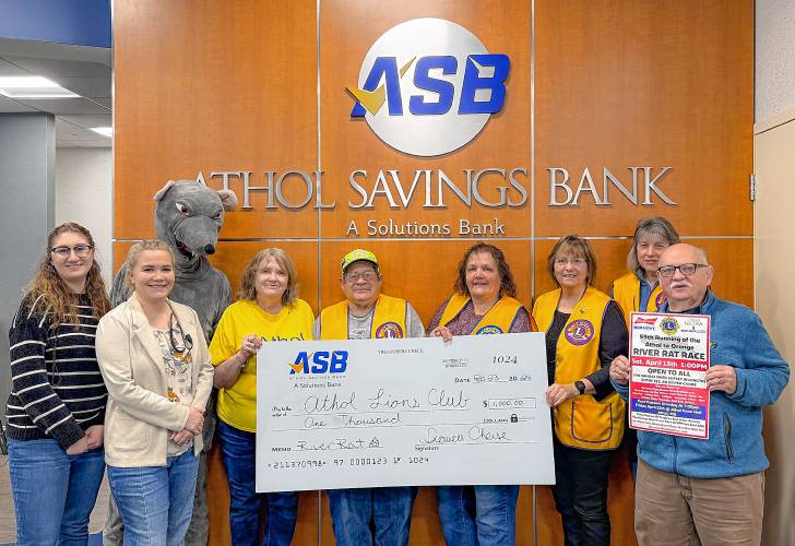 Pictured (from left) are Athol Savings Bank Employees Joanie Hannu and Taylor Crawford, River Rat Mascot “Paddles,” Race Tri-Chair Lion Sharon Hatstat, Lion John Baldasaro, King Lion Raenette Kramer (president), Lion Secretary Deborrah Porter, Lion Kathy Chaisson and Past King Lion Jim McIntosh. 