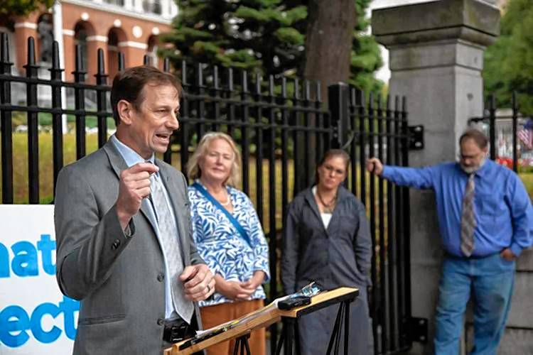 Toby Leary (left), who is chairing The Civil Rights Coalition working to repeal a gun law Gov. Maura Healey signed in July, speaks with reporters outside the State House on Sept. 19.
